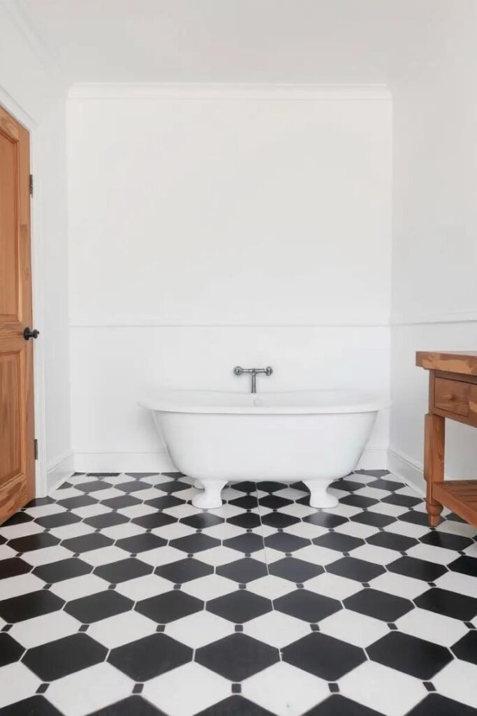farmhouse bathroom with black and white hexagonal floor tiles.