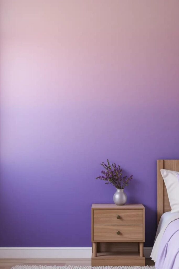 A bedroom wall painted in lavender ombré that transitions from deep at the bottom to light at the top