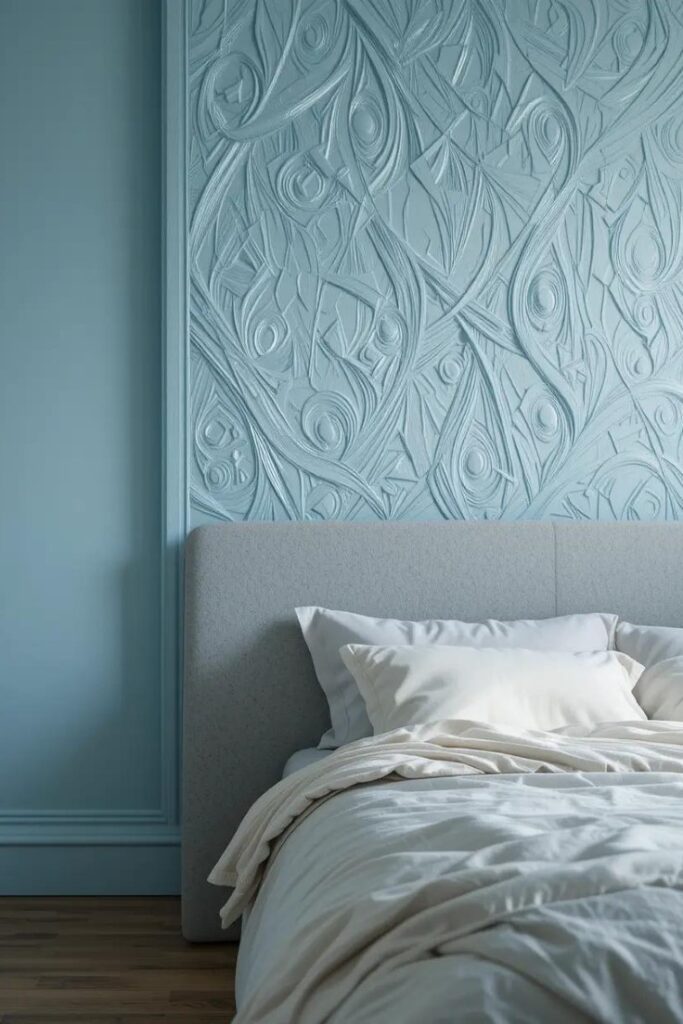 light blue bedroom with a textured light blue accent wall behind the bed.