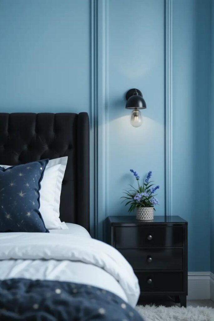 bedroom featuring light blue walls with black furniture.
