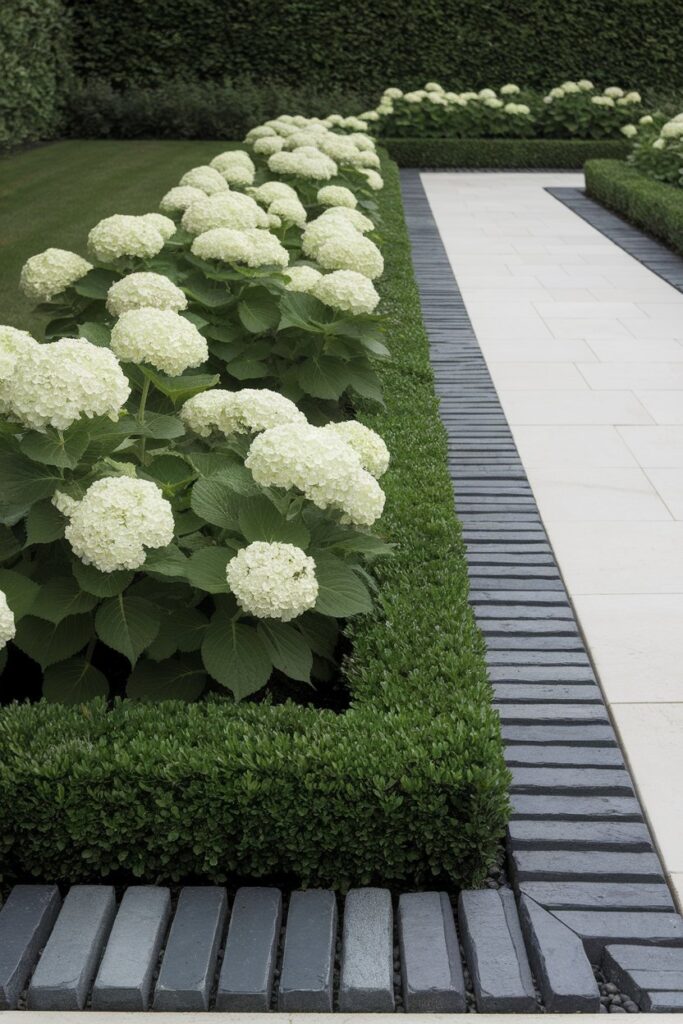 An edged flower bed bordered with mortared stone.
