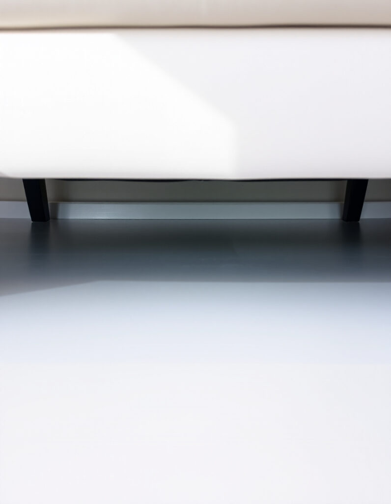 a clean floor space under a couch.