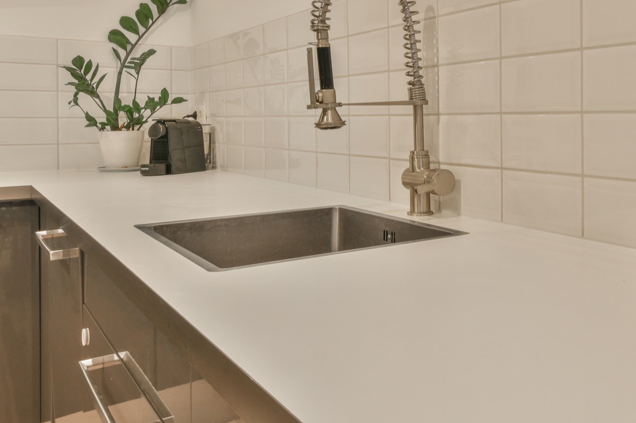 A kitchen with a sink and a faucet.