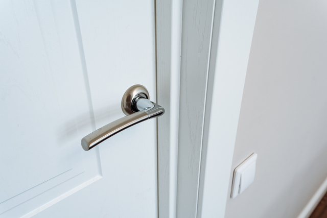 closeup photo showcases white door handles.