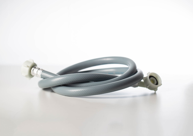 Gray twisted water hose from a washing machine.